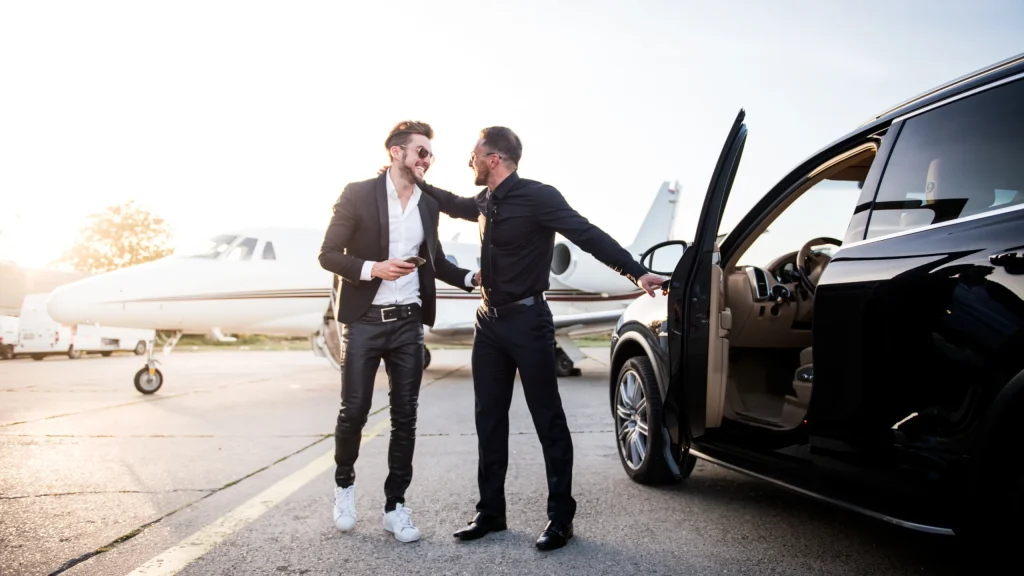 Professional chauffeur opening a car door for a VIP client during travel in Manchester