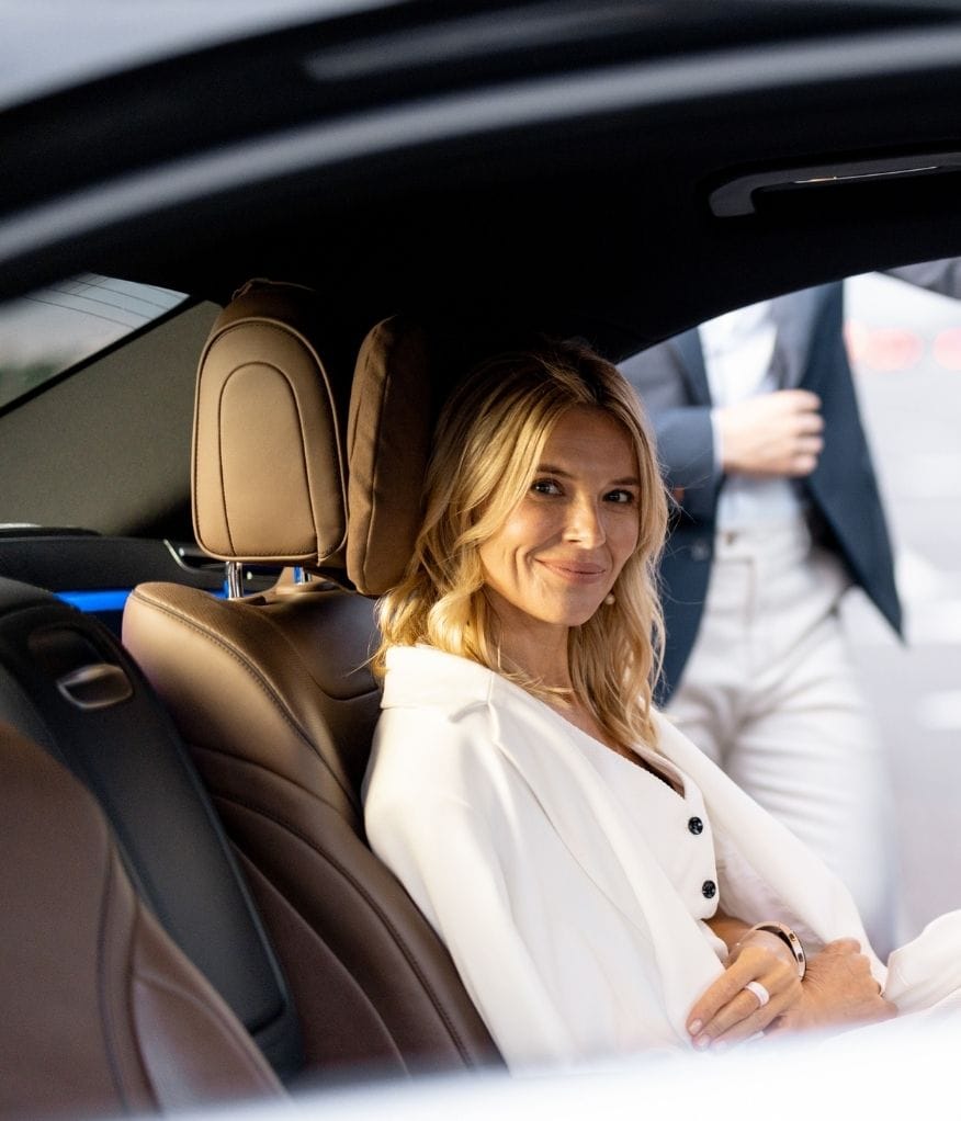 Client smiling inside a chauffeur vehicle