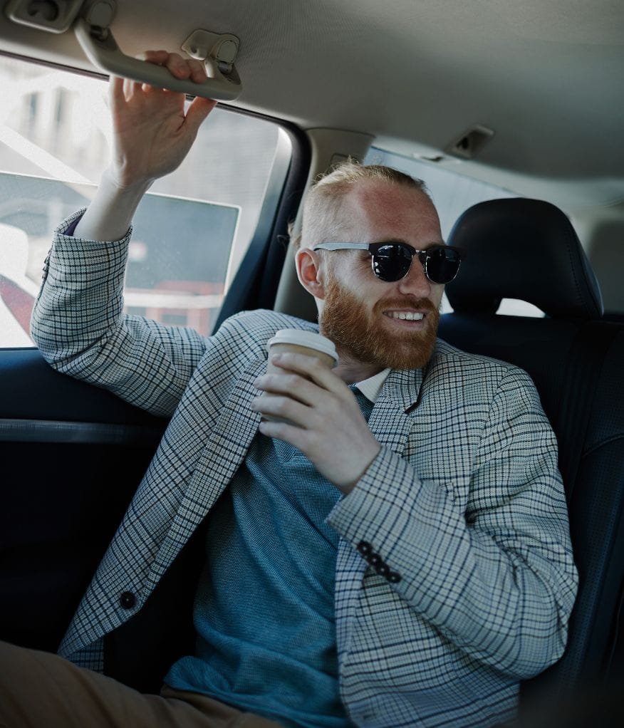 Client enjoying a coffee inside luxury vehicle