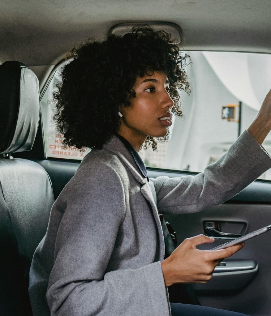airport transfer passenger seated in the back, looking through the front windscreen