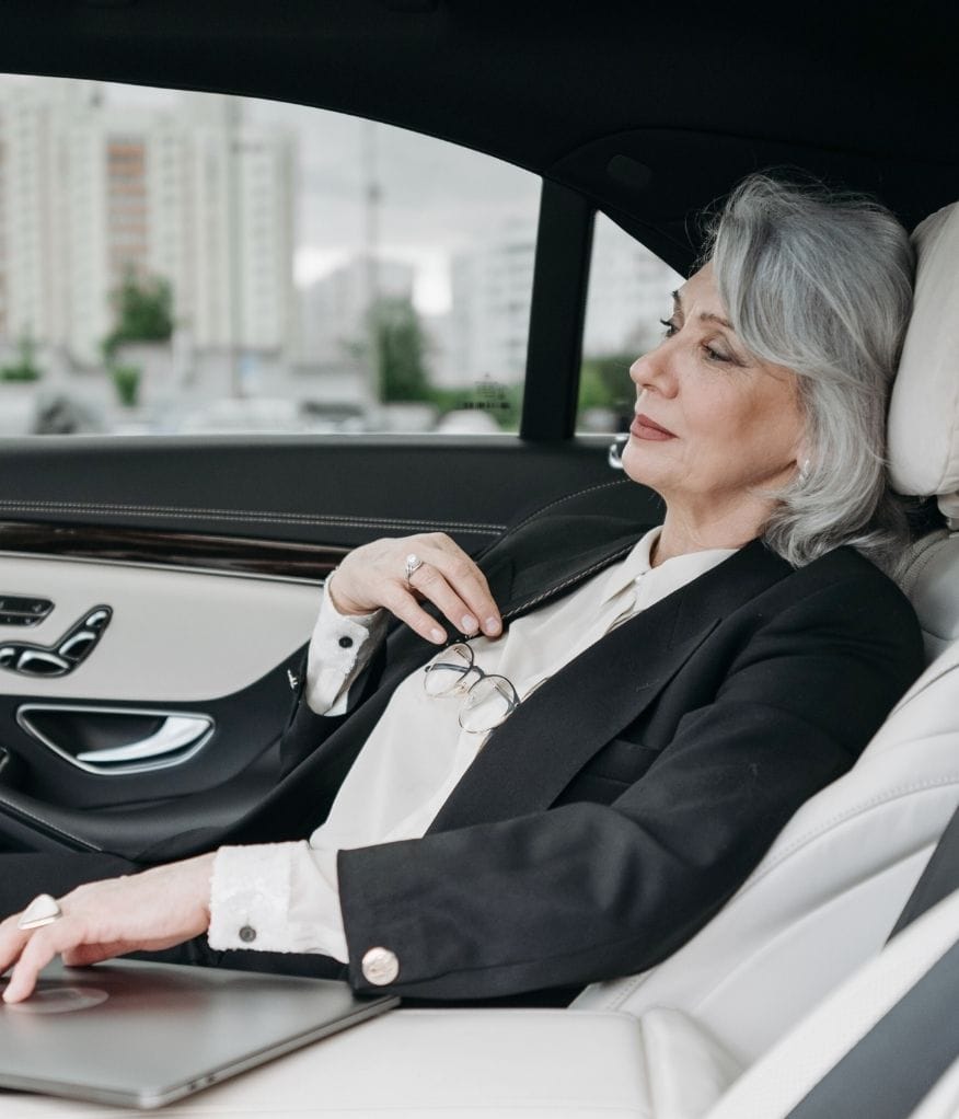 Client relaxing inside a chauffeur vehicle