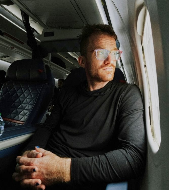 passenger seated by the window inside an aeroplane