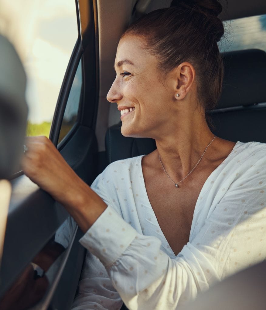 Client smiling inside a chauffeur vehicle