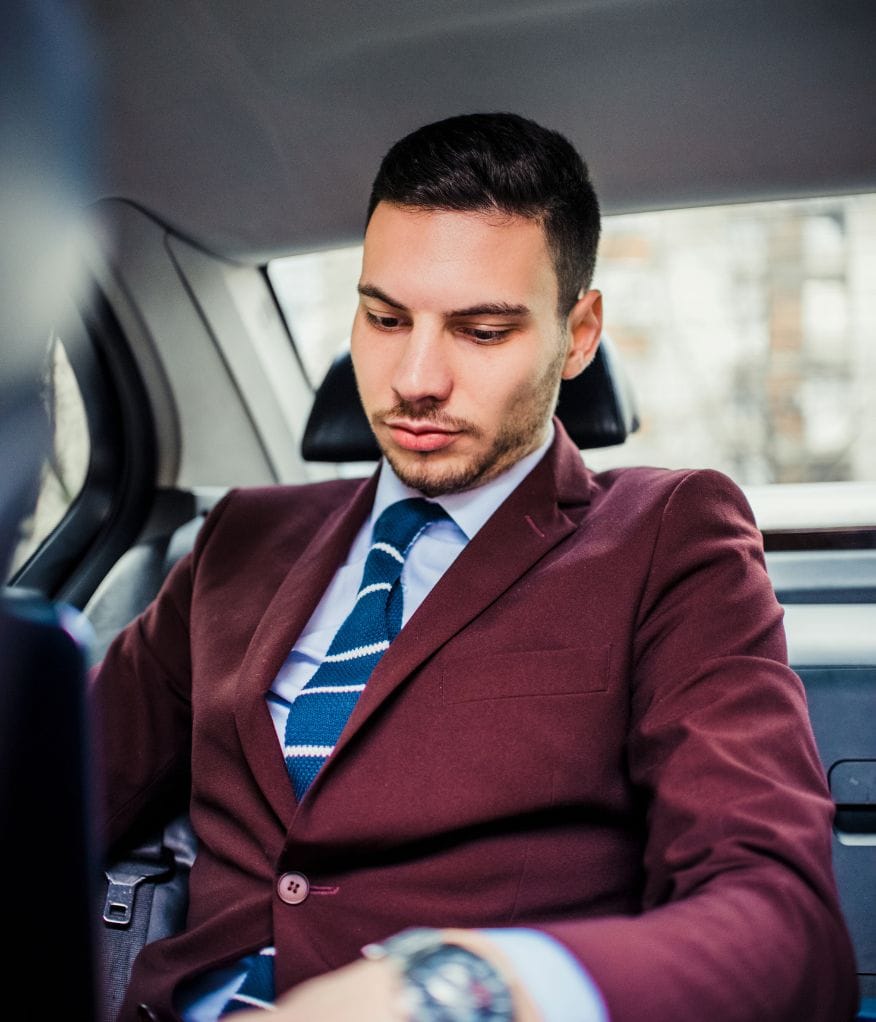 A client sat in the back of a chauffeur vehicle
