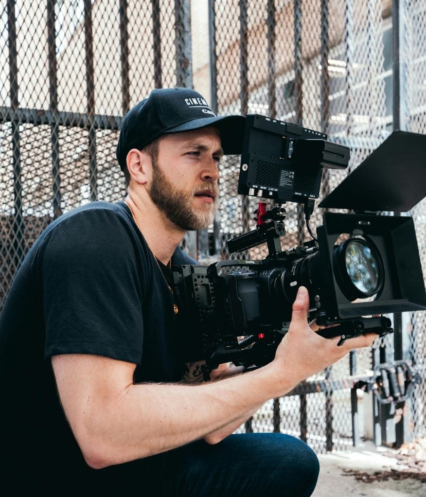 A videographer holding a camera