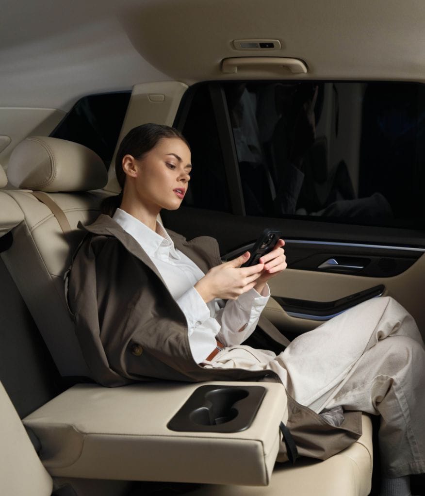 Client checking her phone while en route to a corporate function with an events