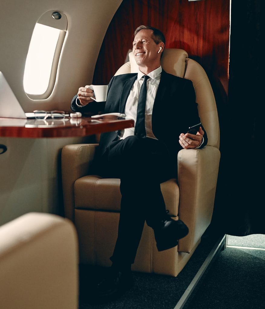 A man enjoying a cup of tea on a private jet