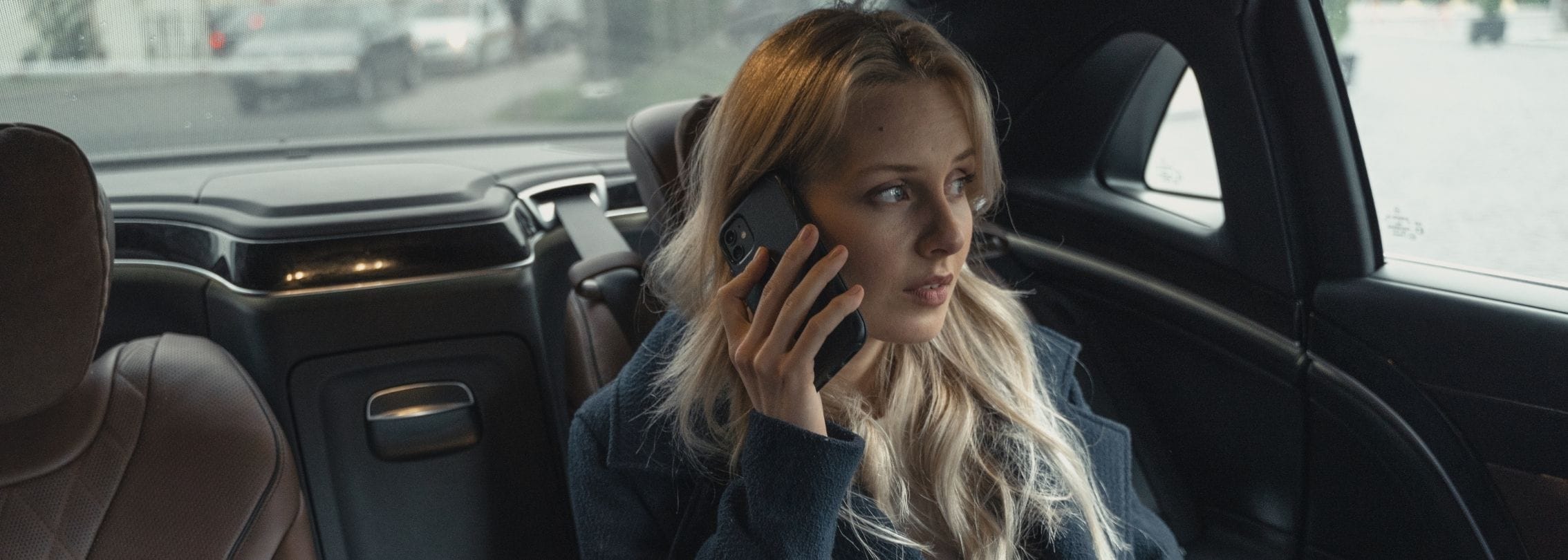 well-dressed VIP passenger making a business call during a ride